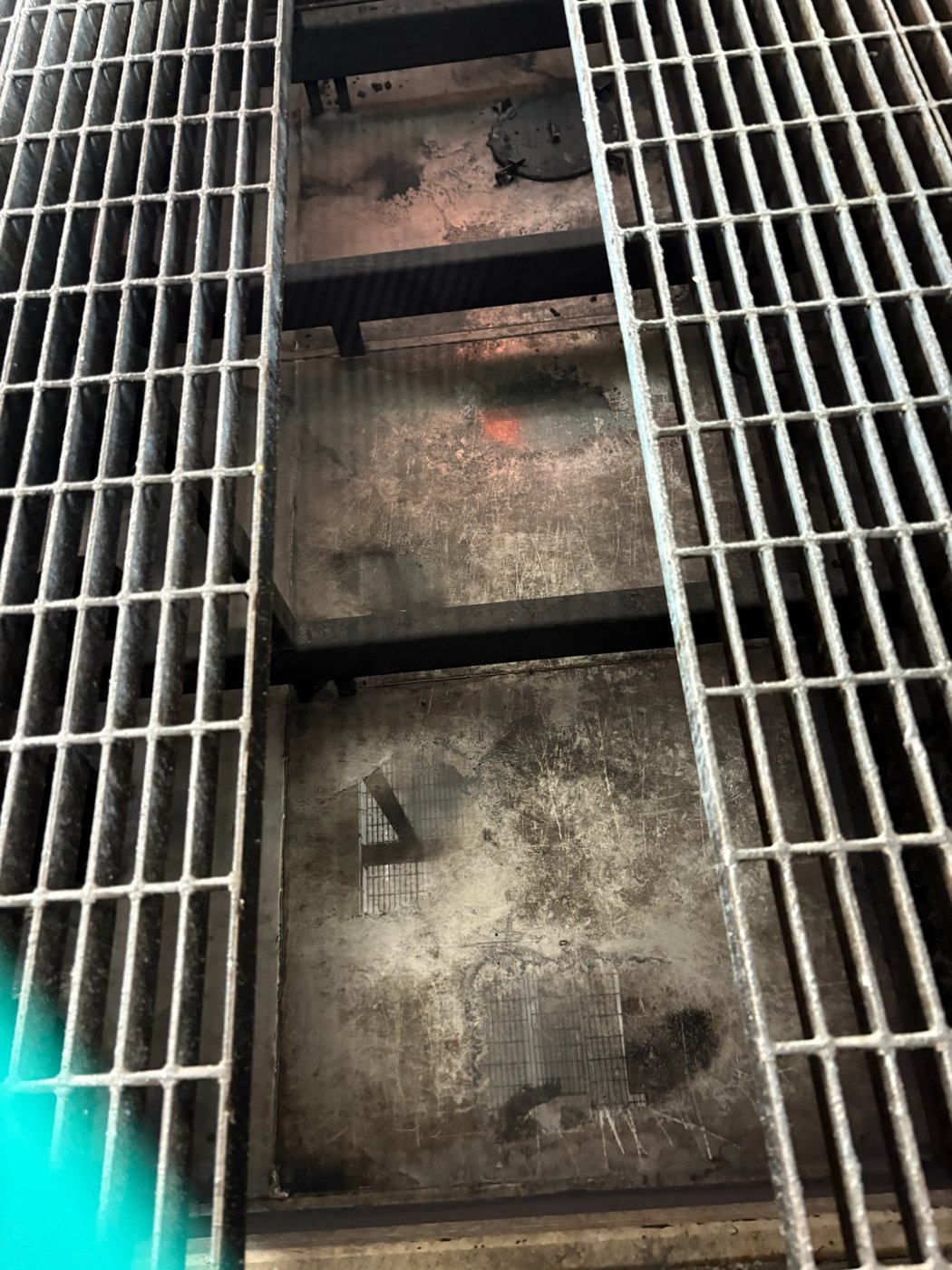 Cleaning beneath floor grating